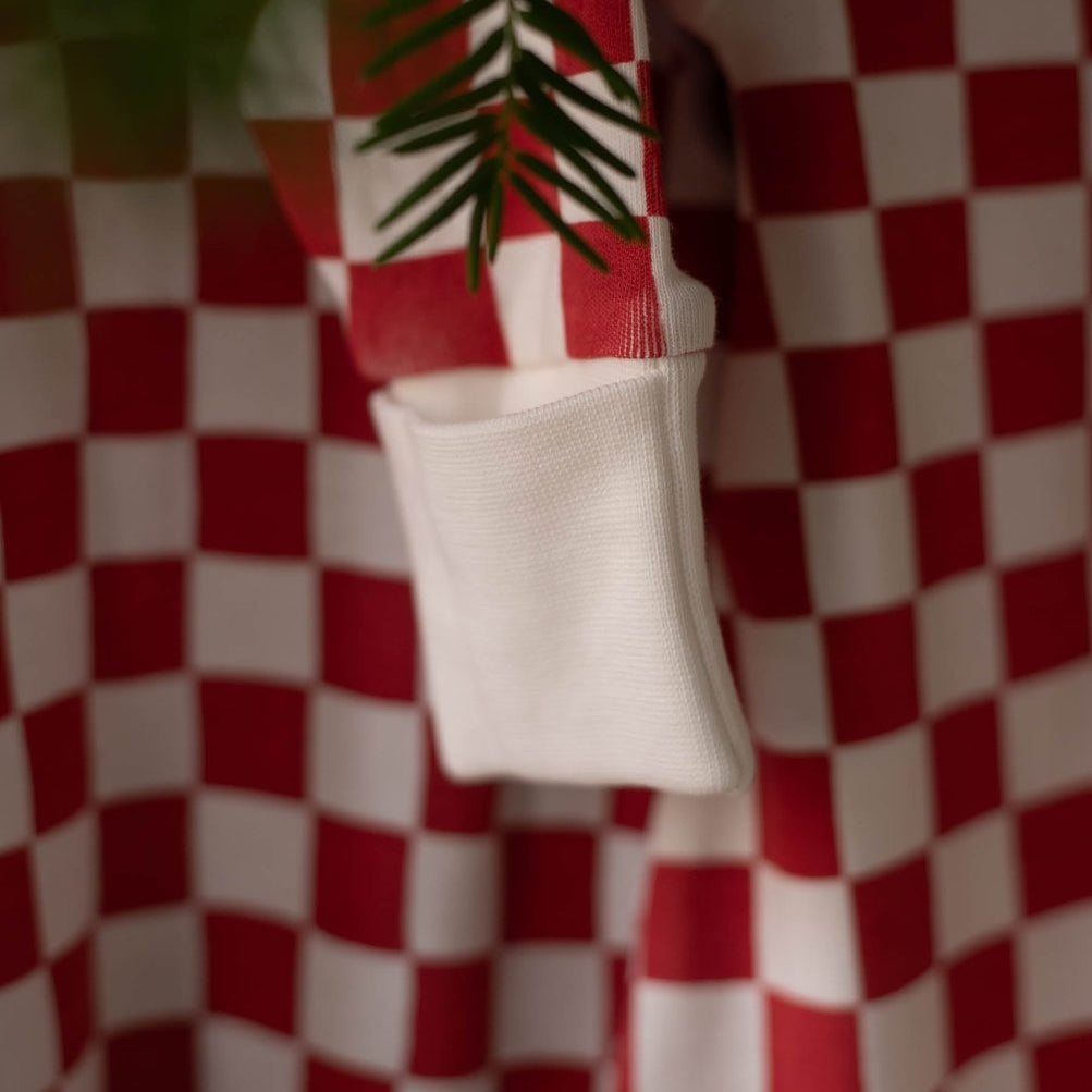 Avery Row Christmas Baby Jersey Sleepsuit - Red Checkerboard – Baby Clothing for children, available at Learning Bugs UK
