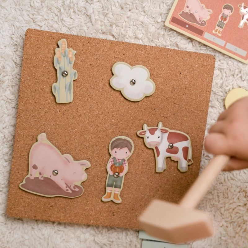 Cork board with animal and character-shaped pins on a light-colored surface