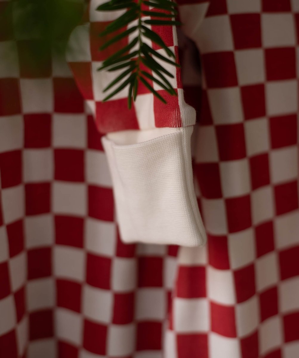 Avery Row Christmas Baby Jersey Sleepsuit - Red Checkerboard – Baby Clothing for children, available at Learning Bugs UK
