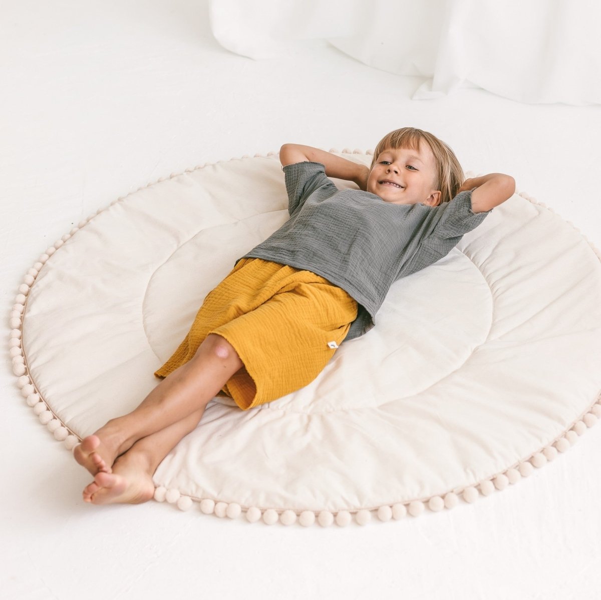 MINICAMP Kids Playmat with Pompom Border in Ecru – Playmats for children, available at Learning Bugs UK