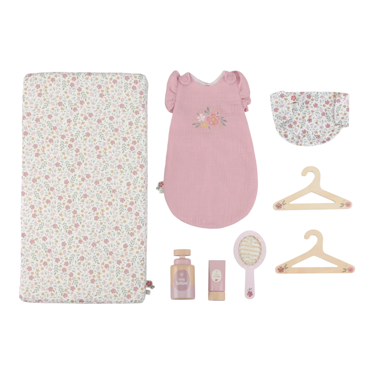 Collection of baby items including a floral crib sheet, pink dress, hat, hangers, and baby care products on a white background.