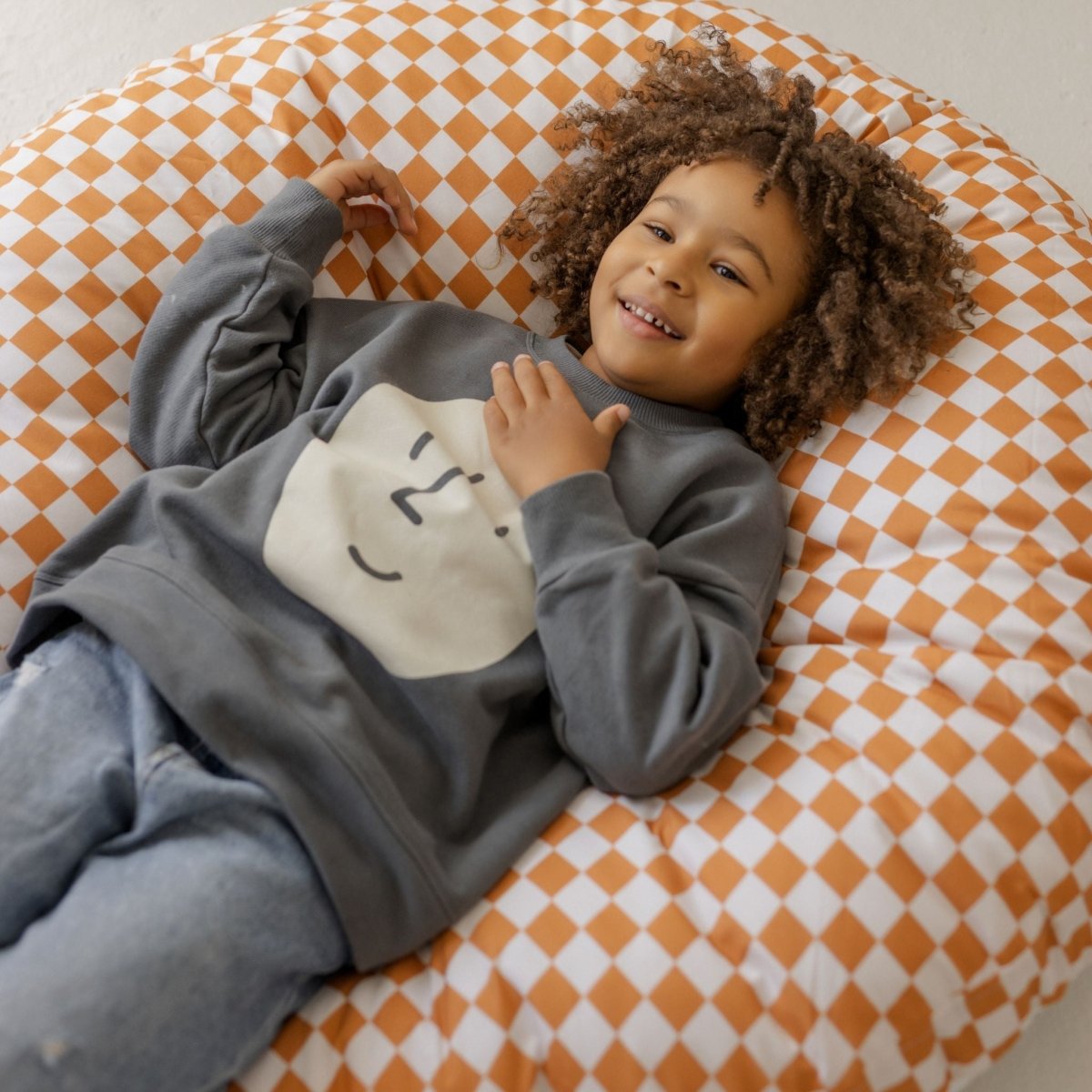 MINICAMP Checkered Large Kids Floor Cushion in Off-white and Orange – Floor Pillows for children, available at Learning Bugs UK